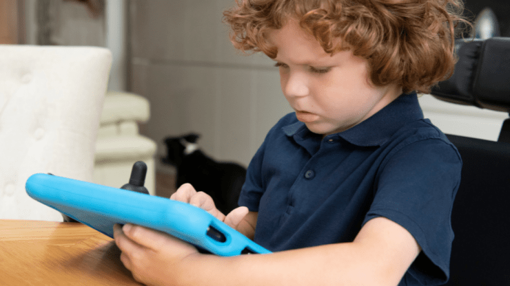 Child holding and looking at a tablet in a blue case