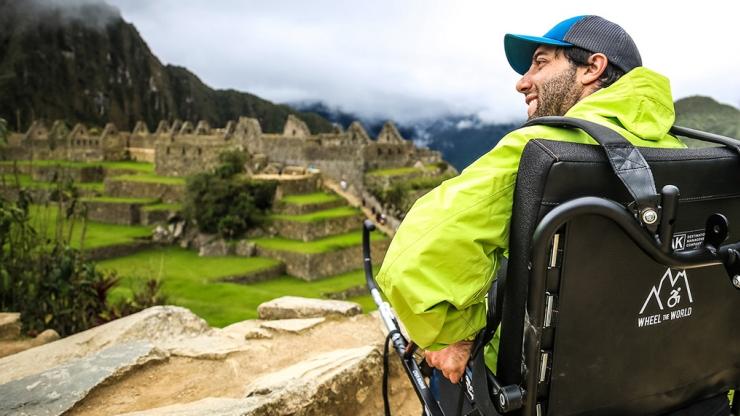 Man in wheelchair looking out at Machu Piccu