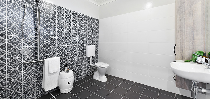 Modern accessible bathroom with dark floor tiles