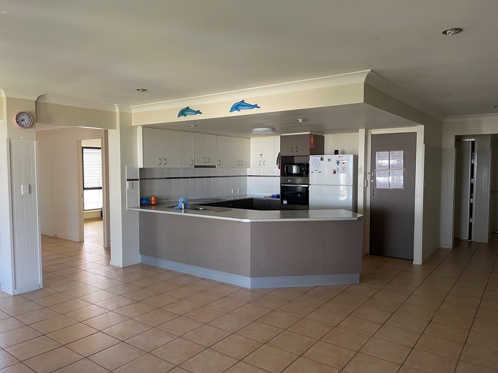 SIL Vacancy in Sunshine Coast show a tiled, large open plan shared living space and kitchen with bench
