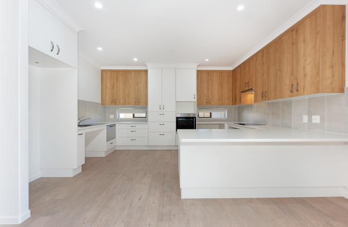 Kitchen with white cabinets and large preparation bench