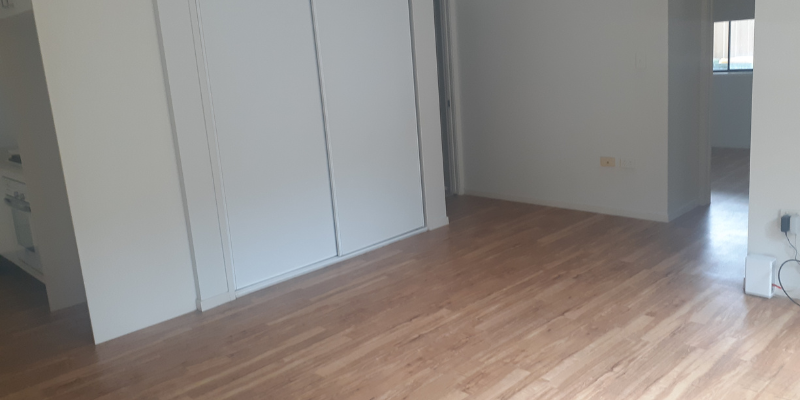 Another angle of the bathroom, showing the wardrobe and the flooring. 