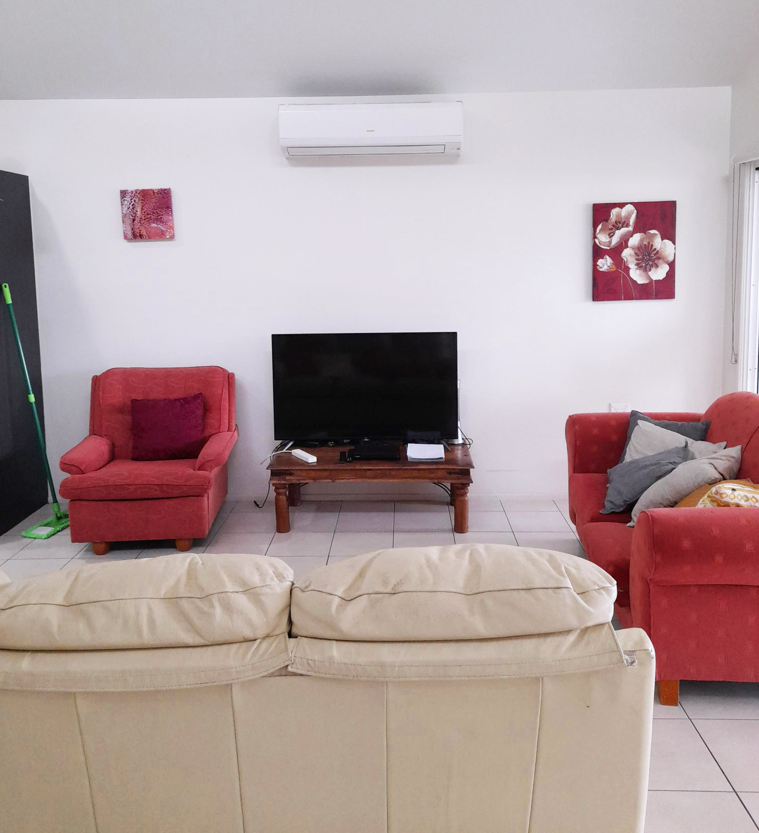 Melissa Street - lounge room with red and cream couches