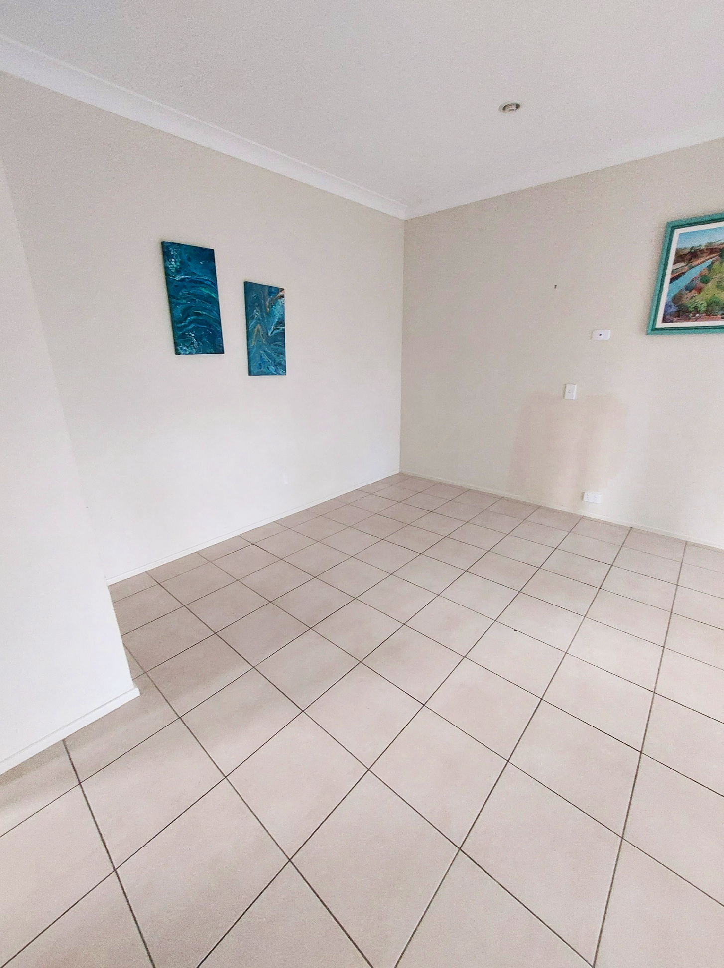 Melissa Street - Hallway with cream walls and white tile floors