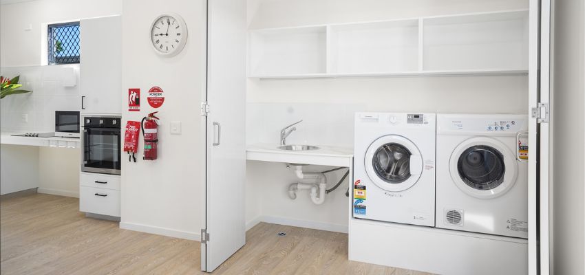 White laundry area with a washer and dryer