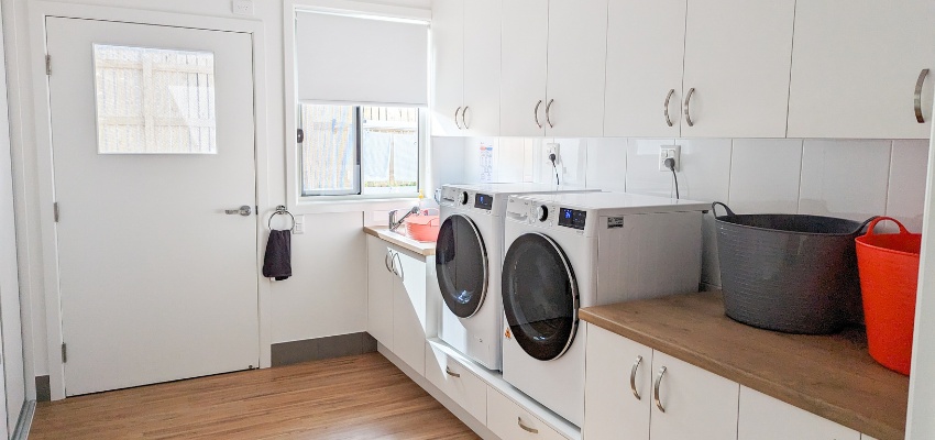 an image of the laundry room, which includes a door to the outside