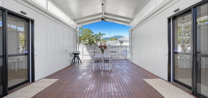 Outdoor patio with dining table and barbecue