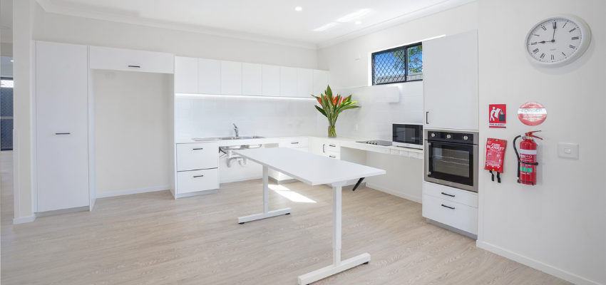 White kitchen with a wooden floor