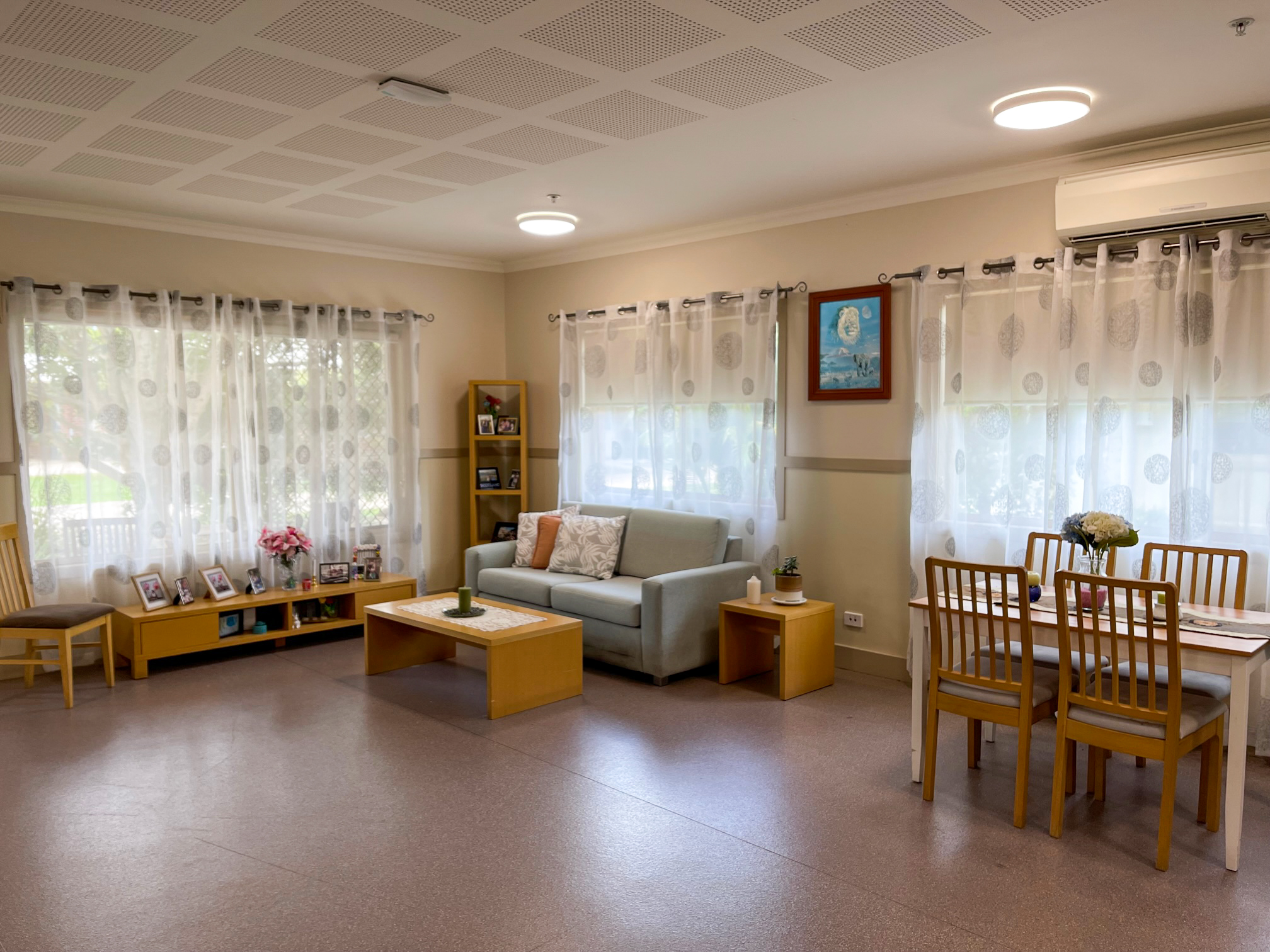 A lounge room with large windows and a couch