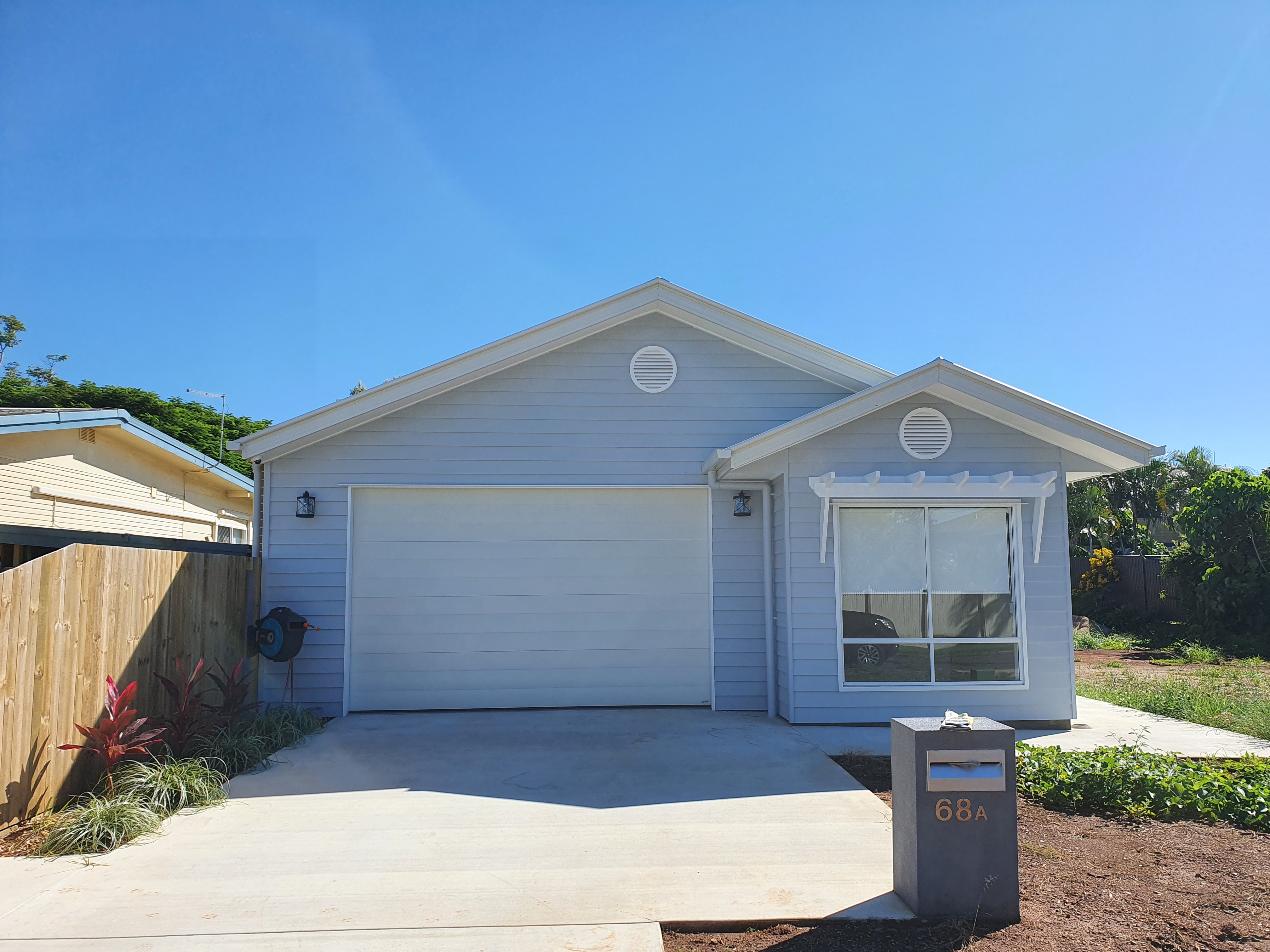 Front of a home with a concrete driveway and large window