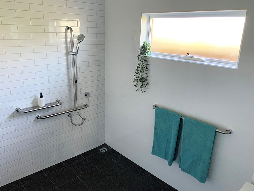 Wet room style shower with tiled floor and walls