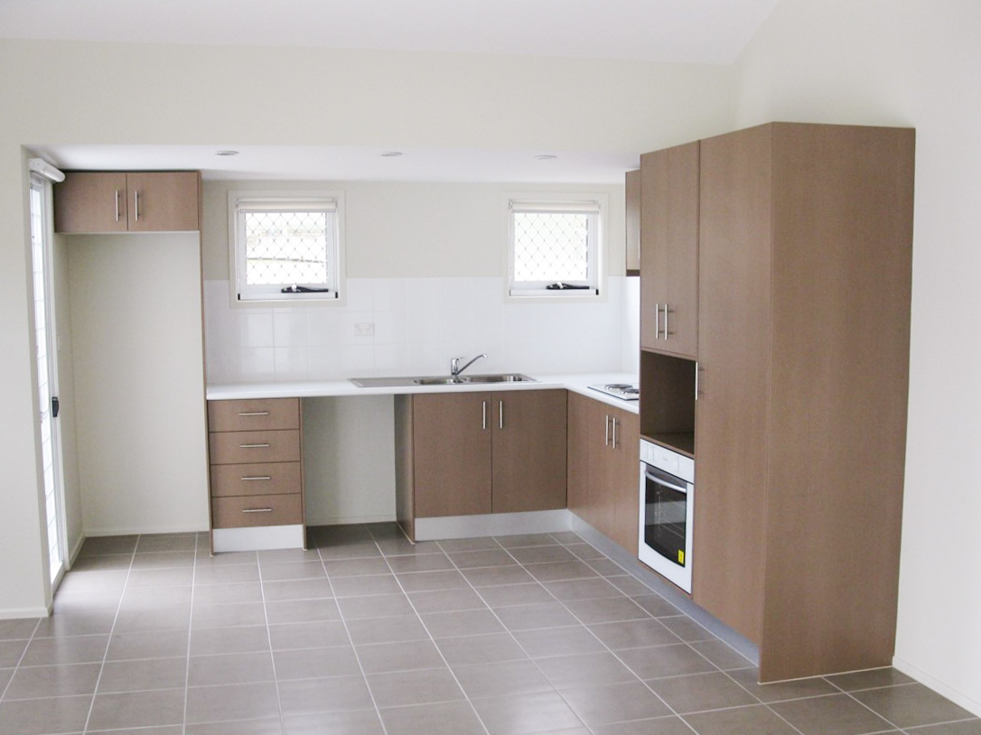 A kitchen with wooden cabinets