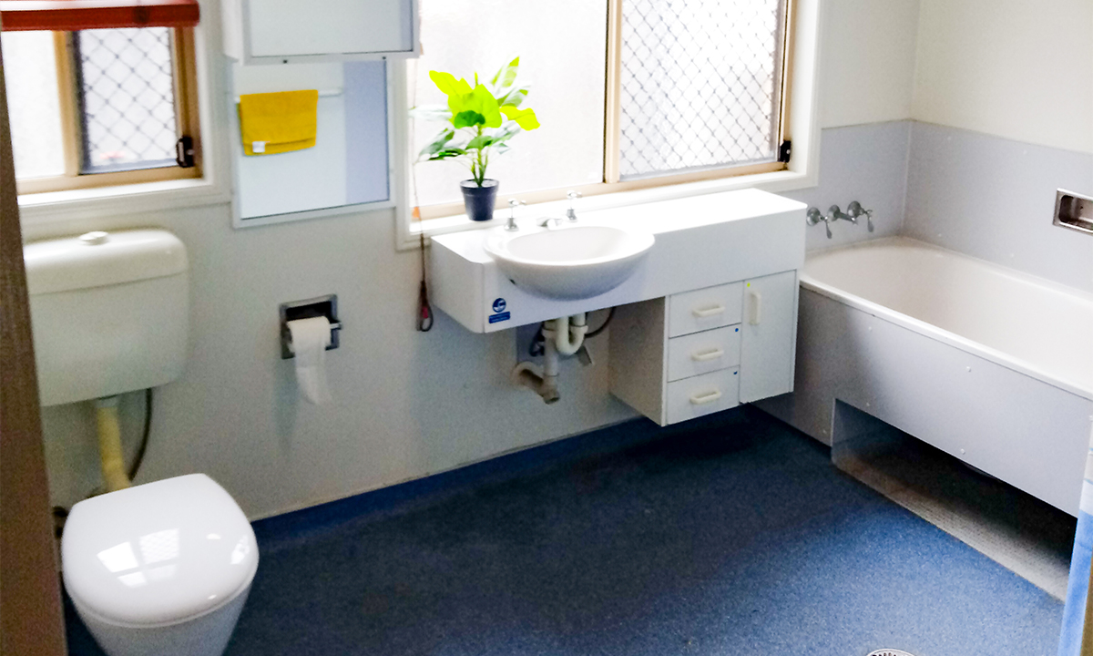 A bathroom with a toilet, sink and bath