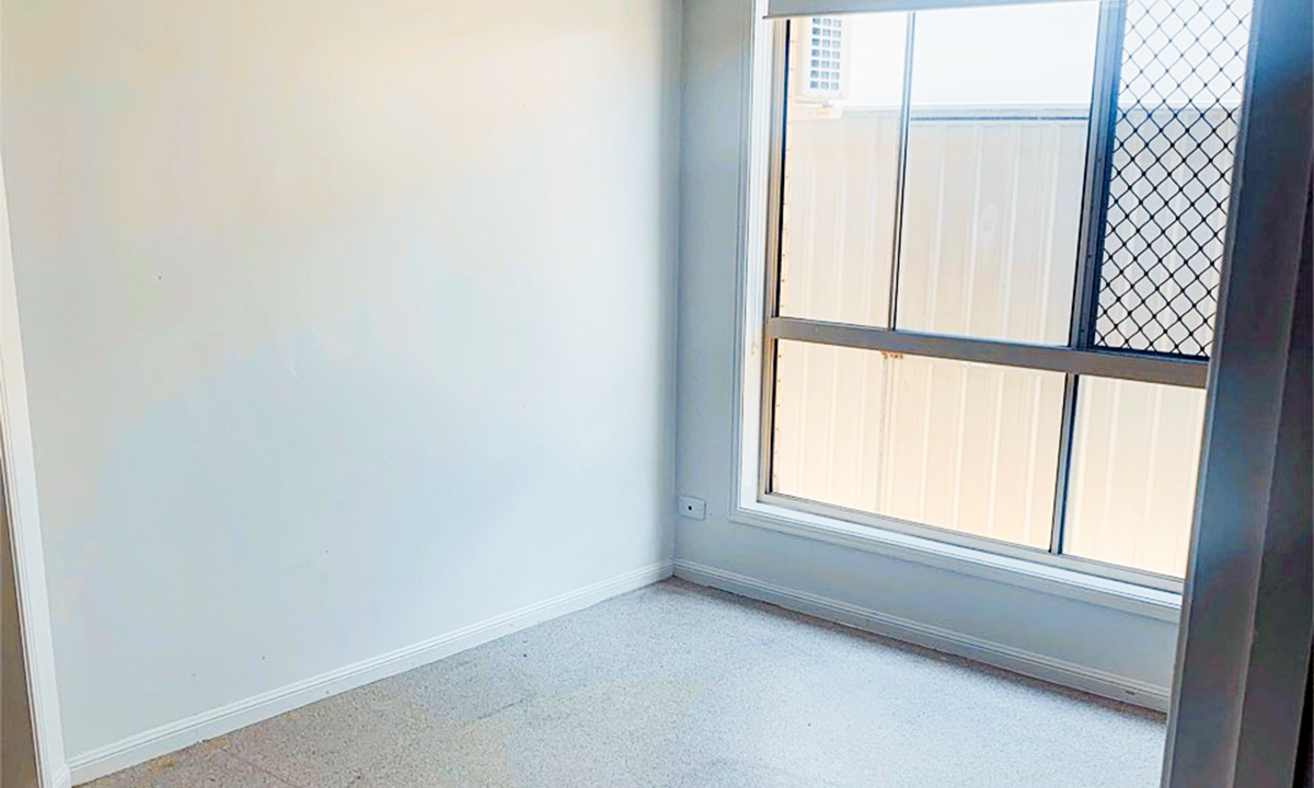 A partial section of a bedroom with a large window