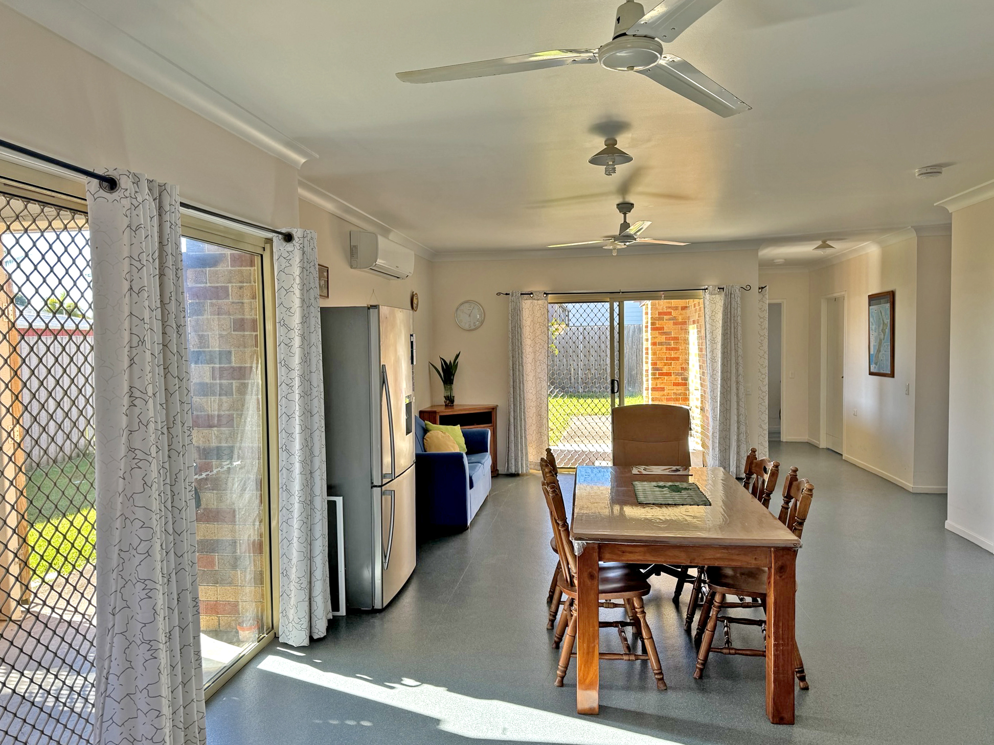 An image showing the dining table and a fridge