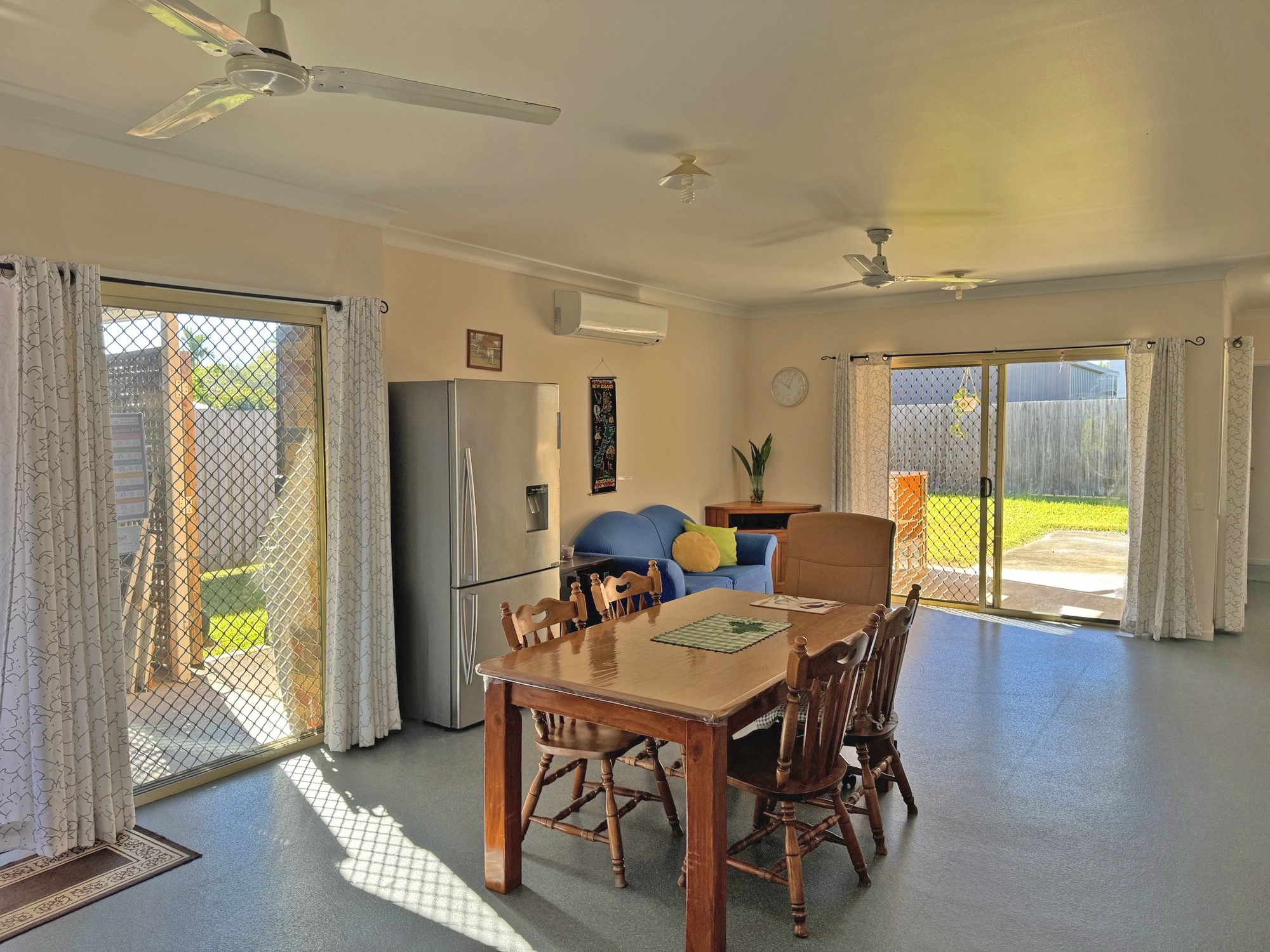 An image showing a dining table and a fridge