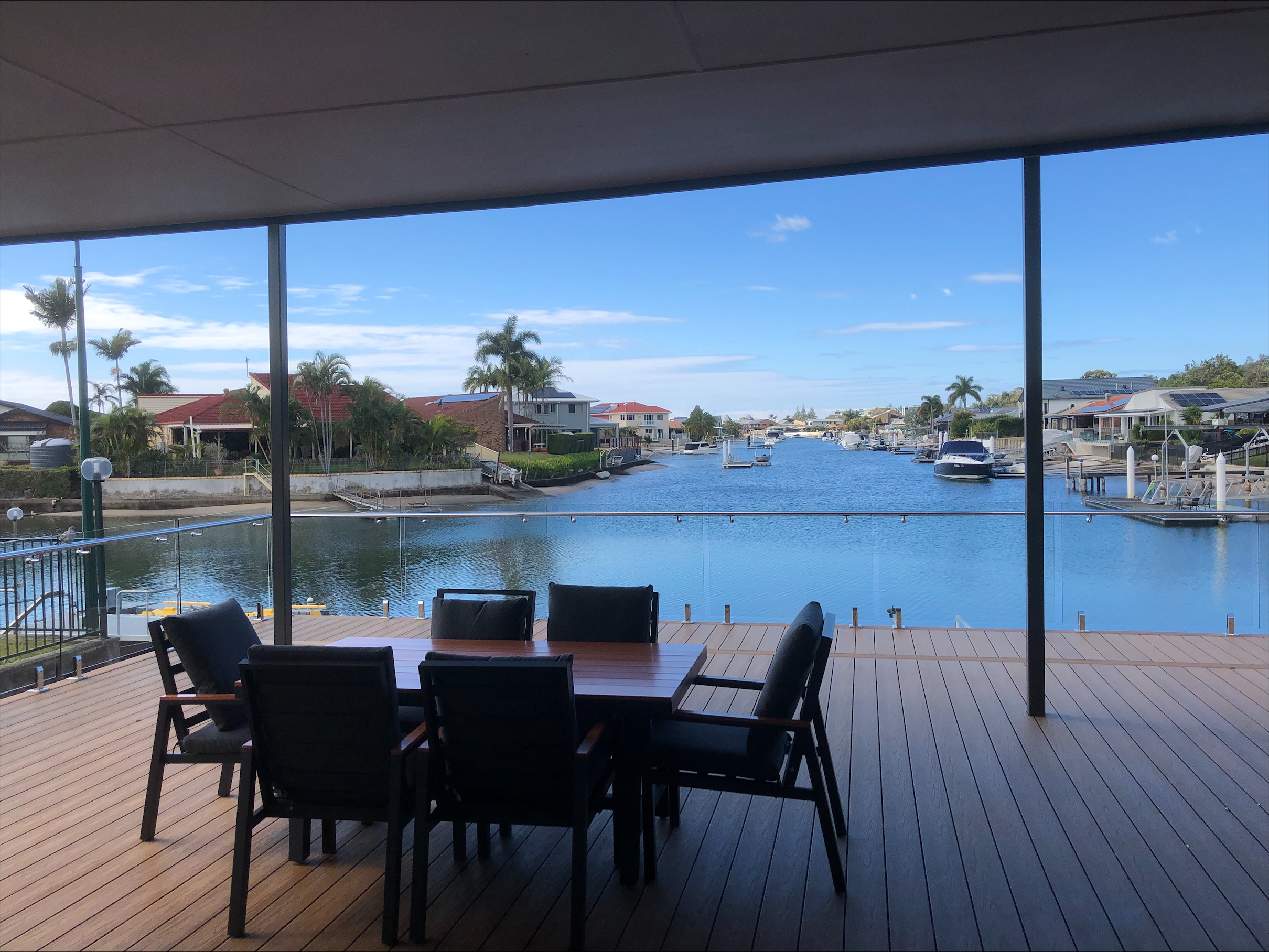 An image showing the back deck, with table, and overlooking the water.