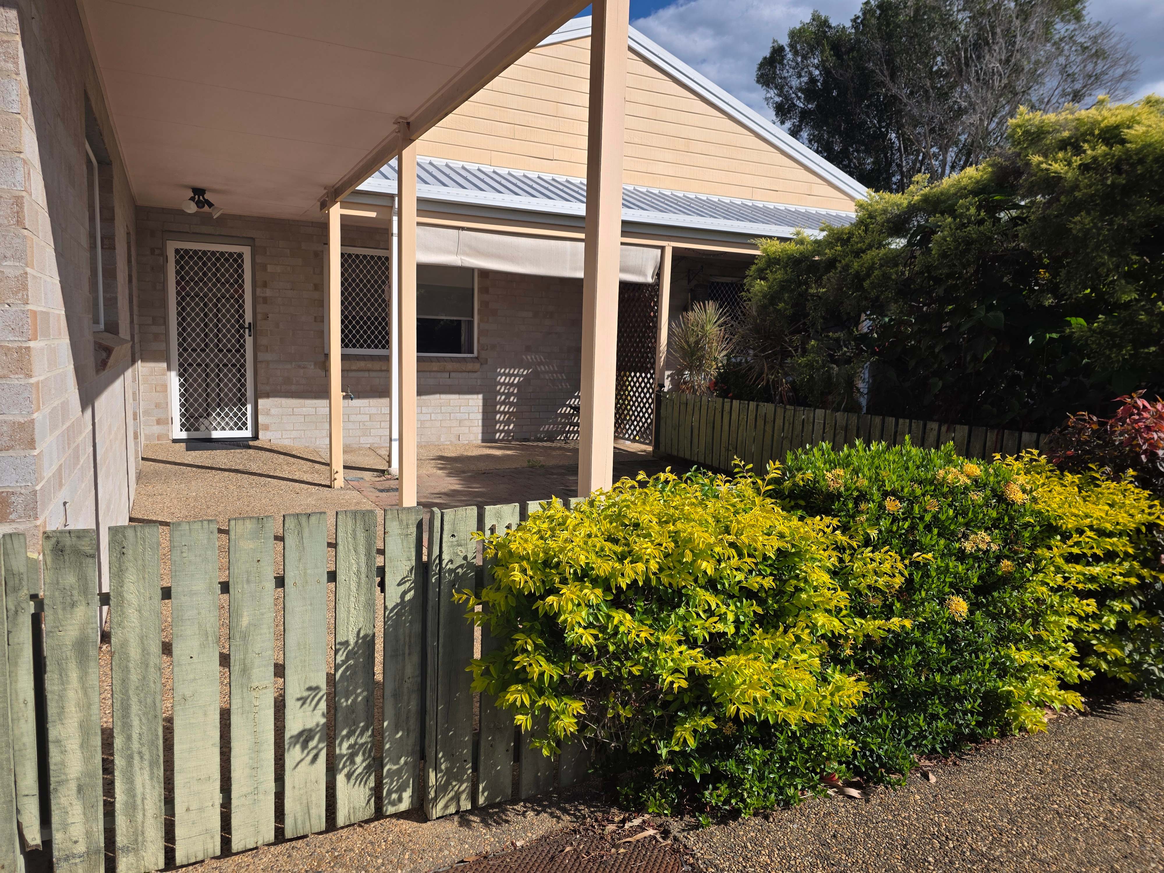 Another image showing the front of the property with the fence visible
