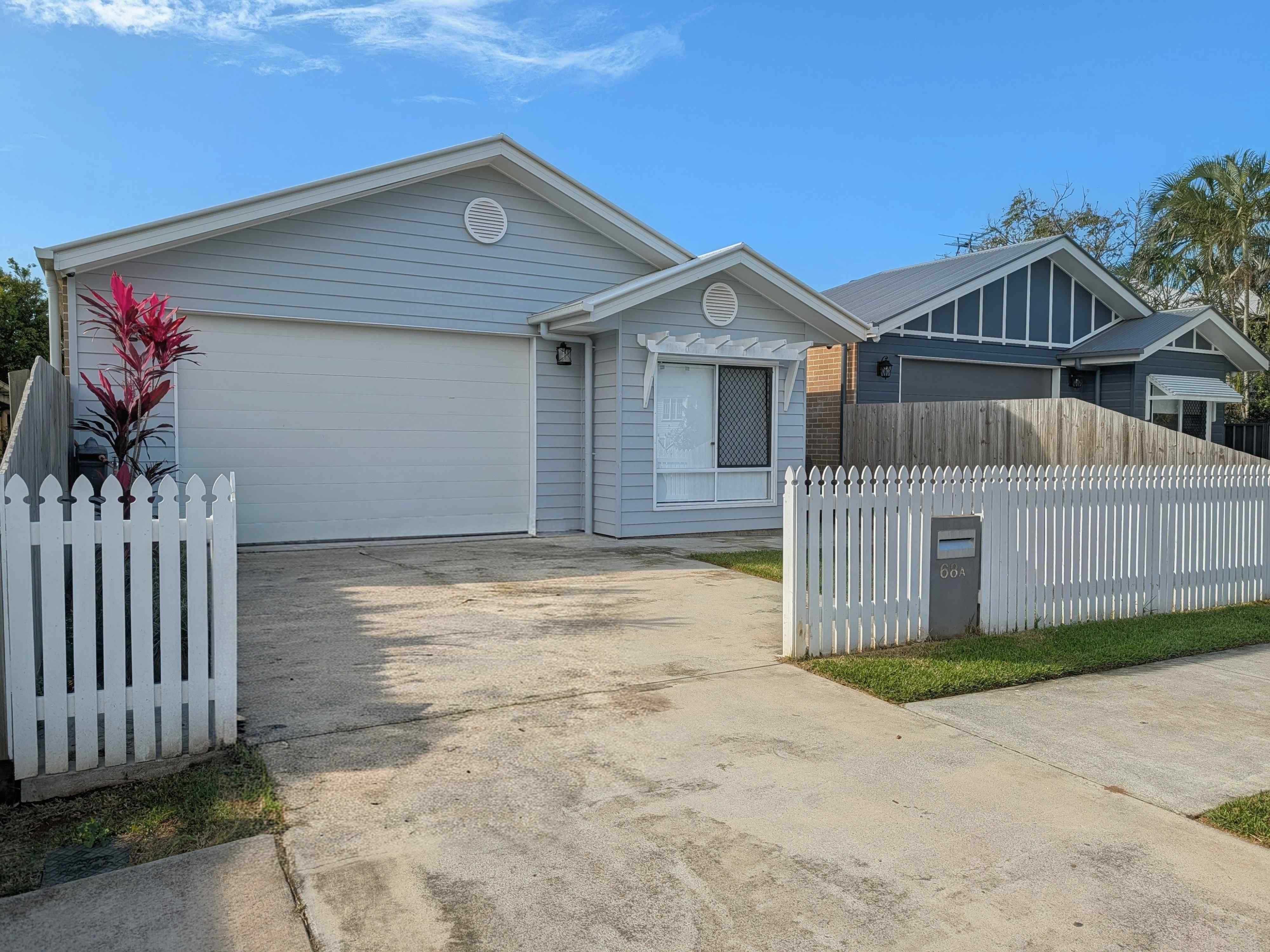 An image showing the front of the property, with the driveway visible and blue sky at the top of the image
