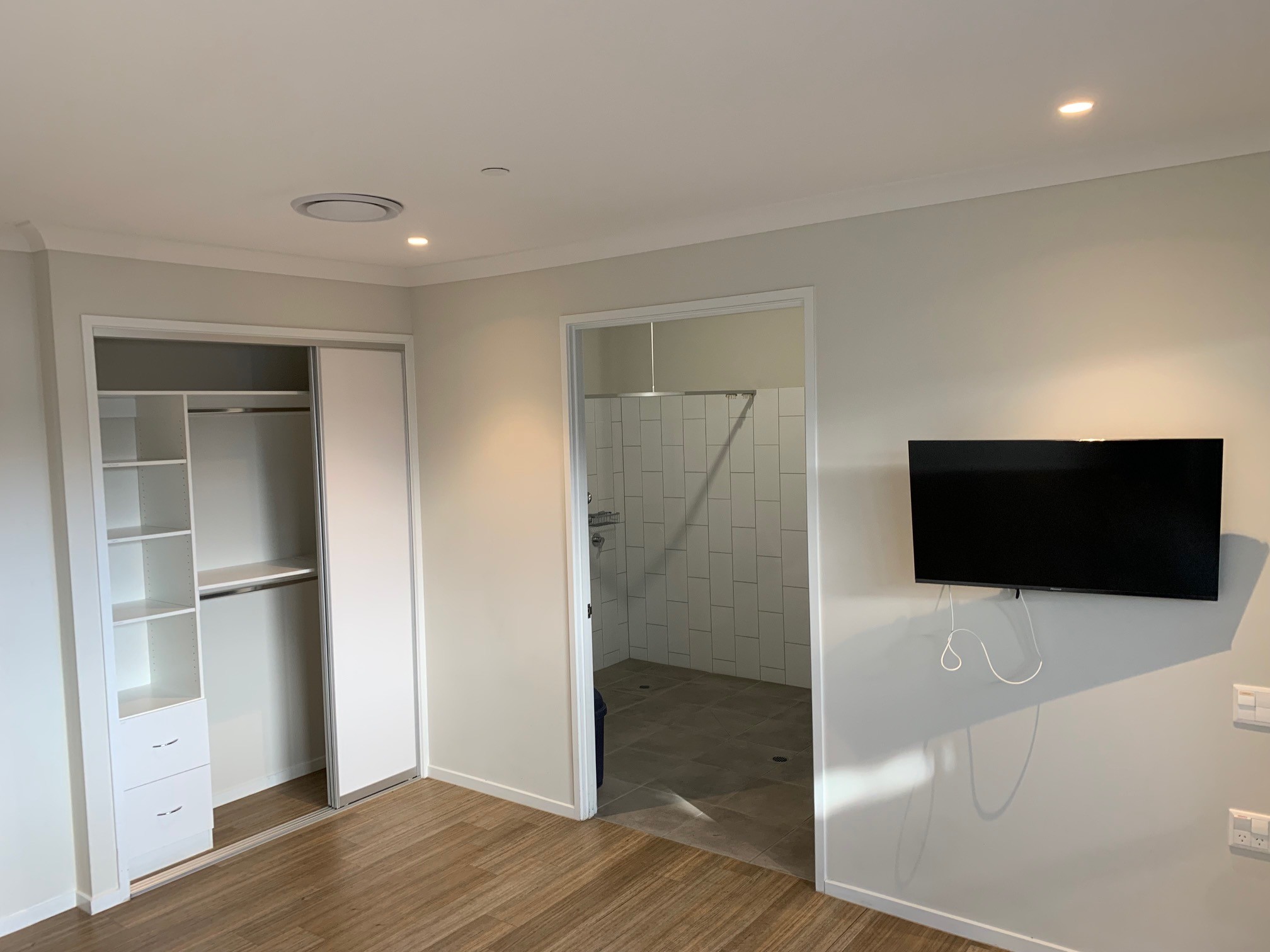An image showing another view of the room with cupboards open