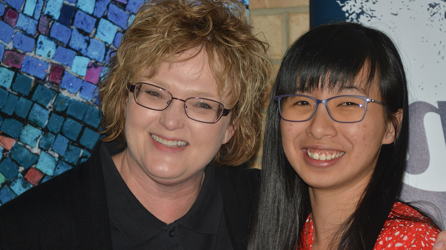 Duyen and Mylestones staff member, two women wearing glasses and smiling