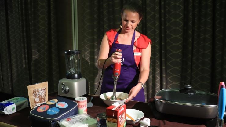 A lady giving a demonstration on how to puree food