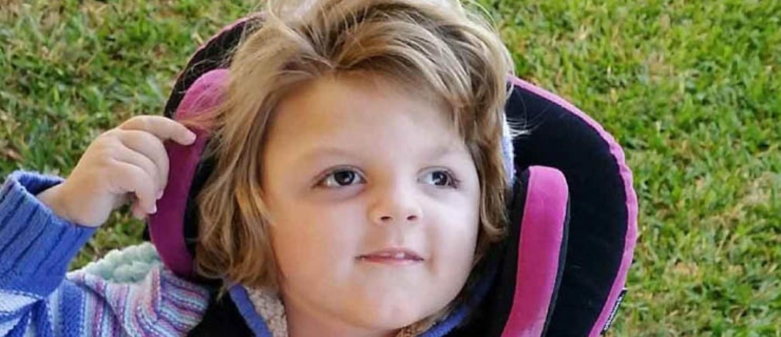 Ava a young girl with a disability who is smiling
