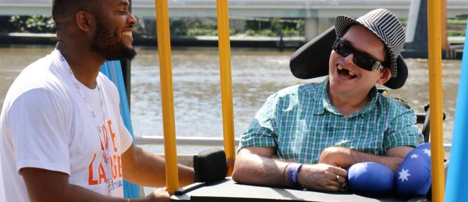 Support worker and teenager by the river